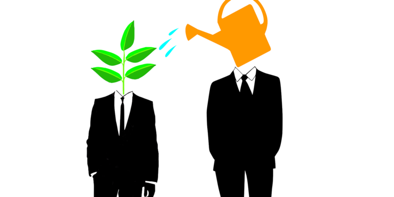 Two people stand next to eachother in black and suits, one is watering the other's plant where there should be a head.