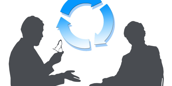 Two silhouettes having a conversation with a circle of blue arrows behind them