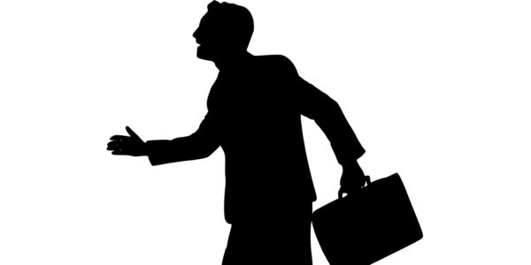 A black silhouette of a salesman holding a briefcase.