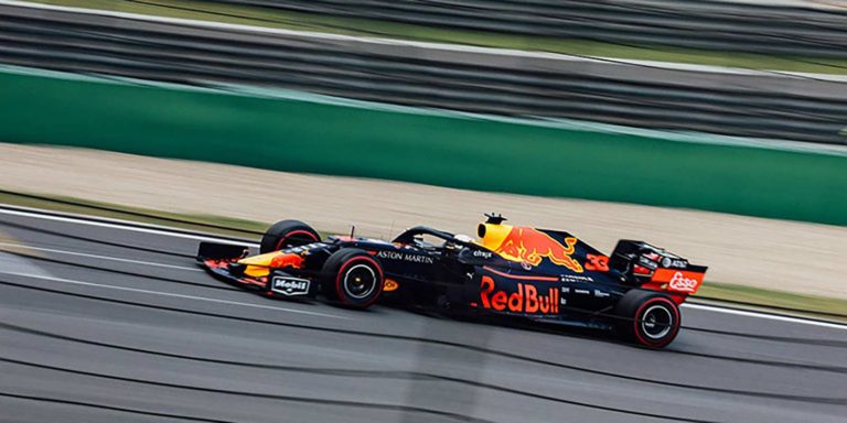 Black Red Bull race car on racetrack representing Red Bull sales acceleration