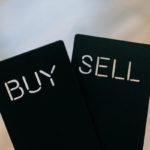 Two black cards with buy and sell written in white font.
