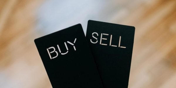 Two black cards with buy and sell written in white font.