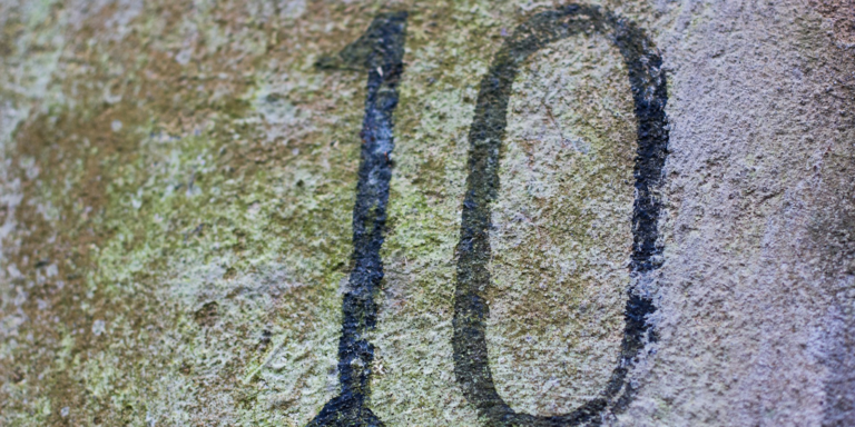 The number ten etched into stone.