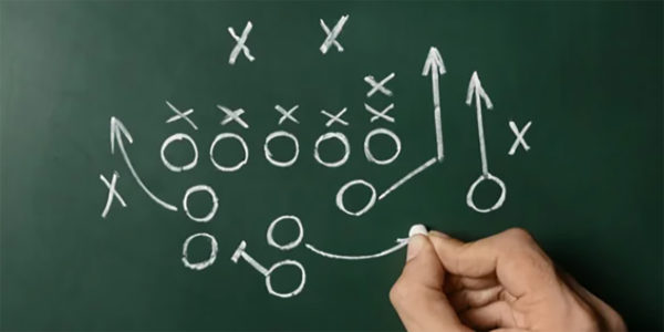 Chalk board with hand drawing X's and O's
