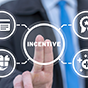 Fingers press a button labeled incentive with other icons surrounding.