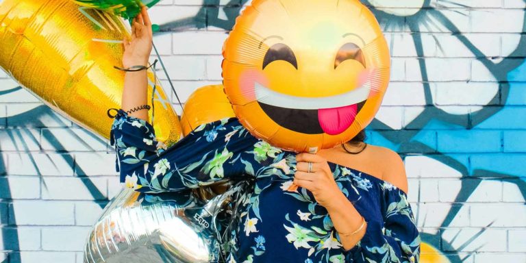 Woman holding balloons.